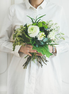 Young woman wearing white clothes holding bouquet  Flower shop concept