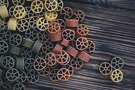 Colorful wheel pasta on a wooden