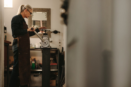 Mature woman working in goldsmith workshop