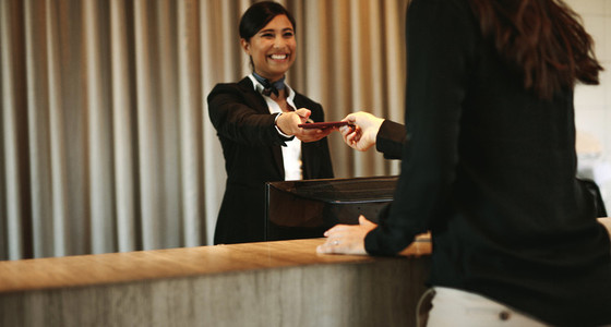 Concierge returning the documents to hotel guest