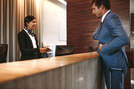 Businessman checking in at hotel reception