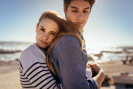 Couple standing together at a beach
