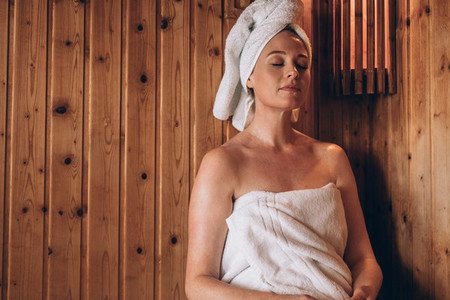 Woman sitting in a spa with eyes closed