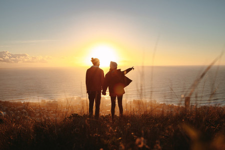 Silhouette of couple standing on mountain