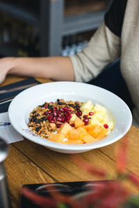 Eating granola with fresh fruits