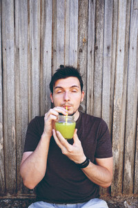 Young man drinking mojito