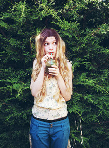 Blonde woman drinking a smoothie
