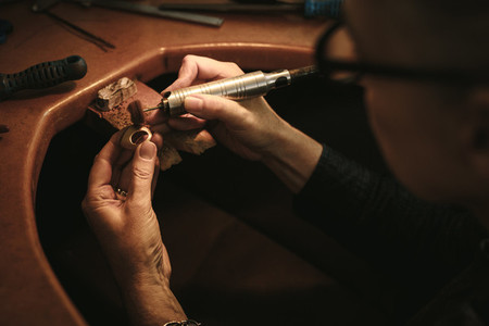 Jewelry designer polishing a ring