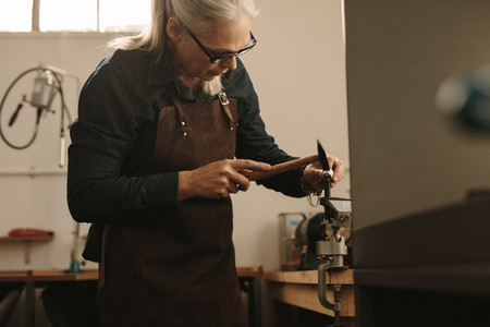 Senior jeweler shaping and designing a silver ring