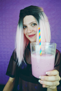 Fit woman drinking a smoothie