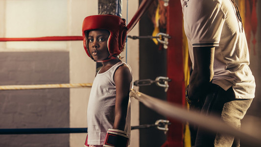 Boxer kid standing in the boxing ring