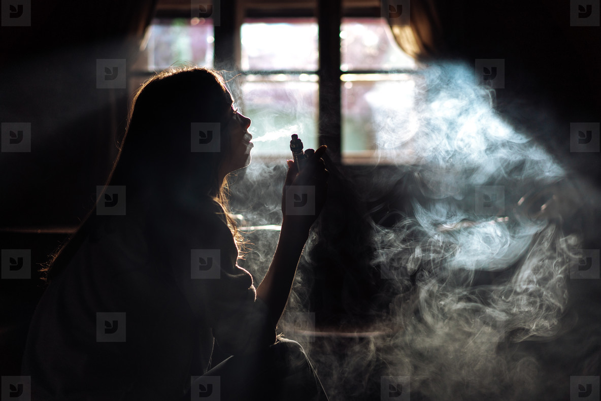 The girl smoke electronic cigarette