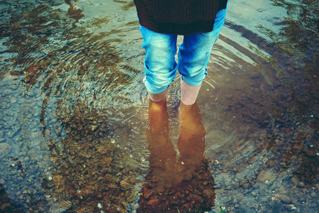 Woman feet in cold water