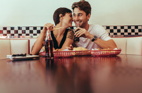 Happy couple at a restaurant eating food