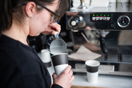 Female barista makes coffee