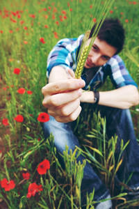 Young relaxed man in a field