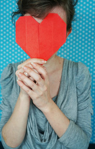 Woman holding a paper heart