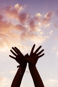 Hands against sky