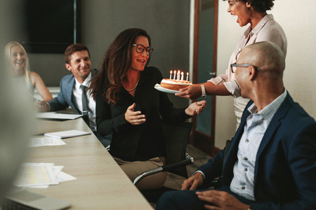 Surprise birthday celebration of a female during office meeting