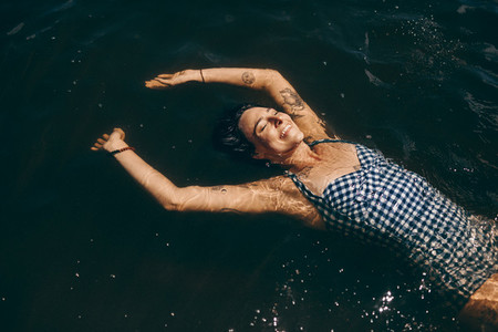 Woman relaxing by floating in water