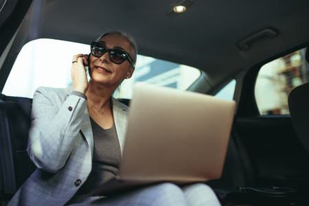 Female entrepreneur traveling to office in a luxury car