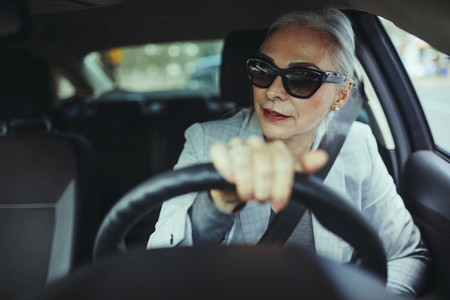 Senior woman driving a modern car