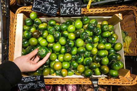 Italian green tomatoes in a groc