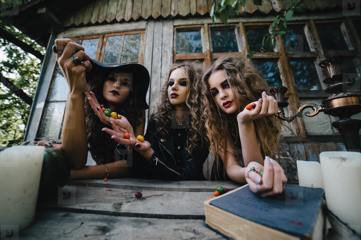 Three vintage witches perform magic ritual