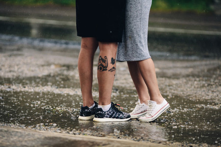 couple on the background of wet asphalt