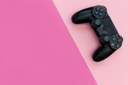 Video game controller bright pink background
