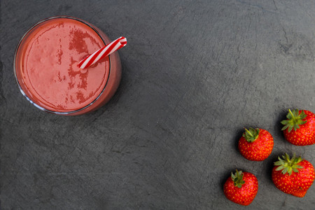 Red smoothie strawberries drink dark background