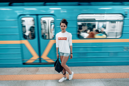 Beautiful young girl posing on metro station