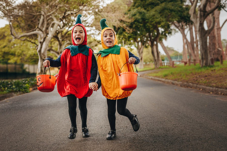 Cute little girls trick or treating in halloween costume
