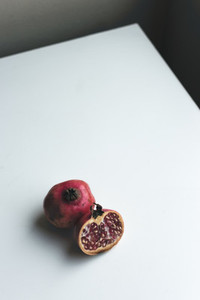 Fresh cut pomegranate on a white