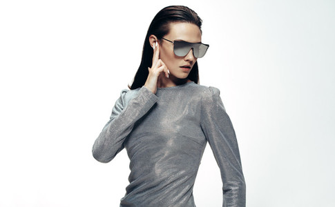 Woman in sliver outfit and mirrored glasses