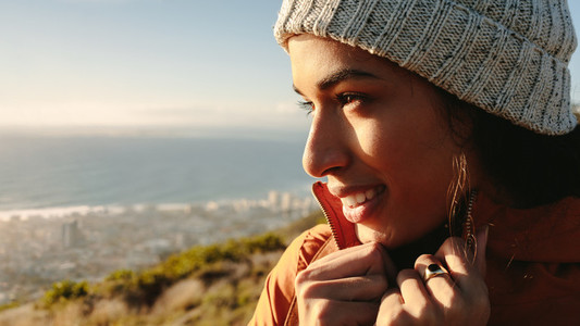 Woman enjoying the seascape view from mountain top on winter day