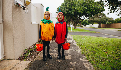 Twin sisters trick or treating on Halloween