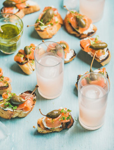 Crostini with smoked salmon and pink grapefruit cocktails in glasses