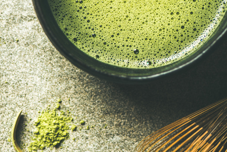 Flat-lay of freshly brewed Japanese matcha tea in Chasen bowl