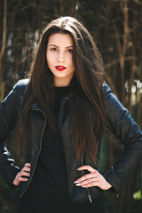 Glamorous young woman in black leather jacket