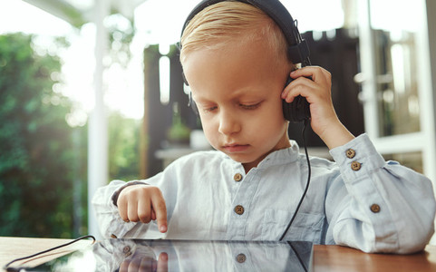 Little boy listening to his selected soundtrack