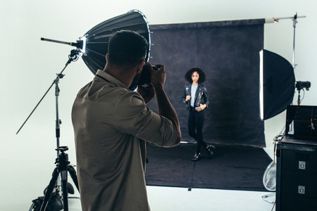 Photographer doing a photo shoot in a studio