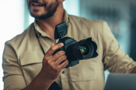 Close up of man holding a digital camera