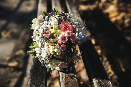 beautiful bridal bouquet lying on a bench