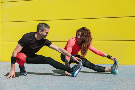 young couple stretching on the floor
