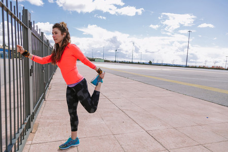 young woman stretching before to run