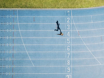 Track and field track with sprinter in overhead shot
