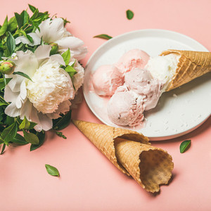 Strawberry and coconut ice cream  waffle cones  white peony flowers