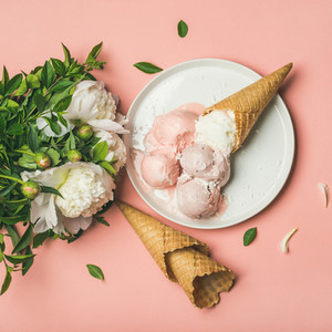 Pink strawberry and coconut ice cream  waffle cones  peony flowers