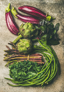 Flat lay of fresh green and purple vegetables